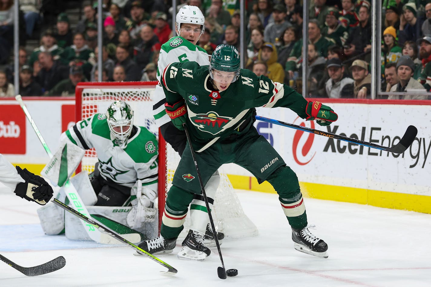 Minnesota Wild left wing Matt Boldy, right, and Dallas Stars defenseman Nils Lundkvist (5) compete for the puck during the second period of an NHL hockey game Monday, Jan. 8, 2024, in St. Paul, Minn. (AP Photo/Matt Krohn)