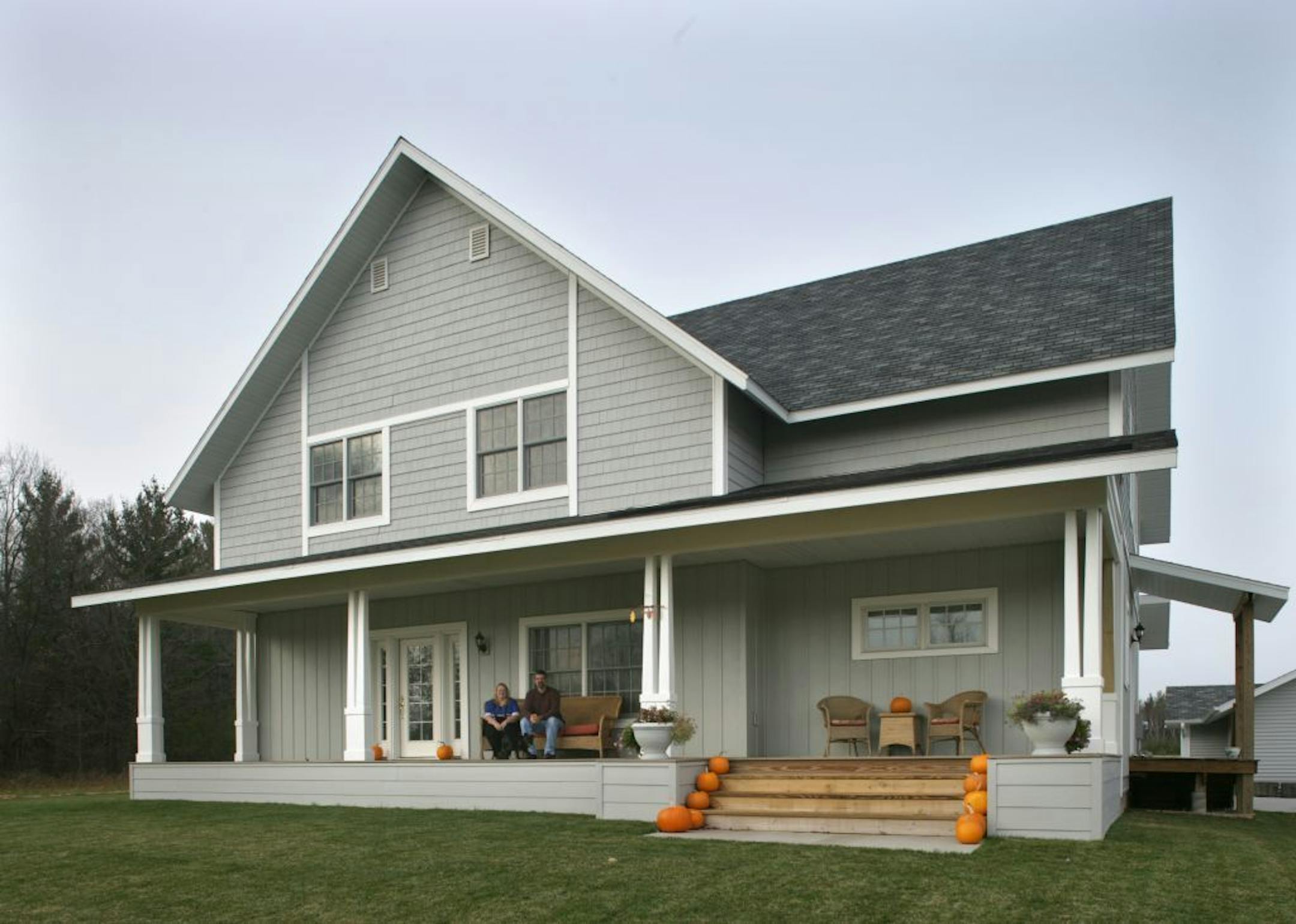 Joel Koyama�jkoyama@startribune.com Andy Griffith would feel right at home in Dave and Marsha Scheurman's home. The couple, such devoted fans of "The Andy Grifith Show" that they met in a fan-club chat room, have now built a faithful replica of Andy's house. Dave designed the exterior himself, and they've furnished the inside to match, down to the blue willow china and Grandma Moses paintings. Marsha and Dave sit on the porch of the house.
