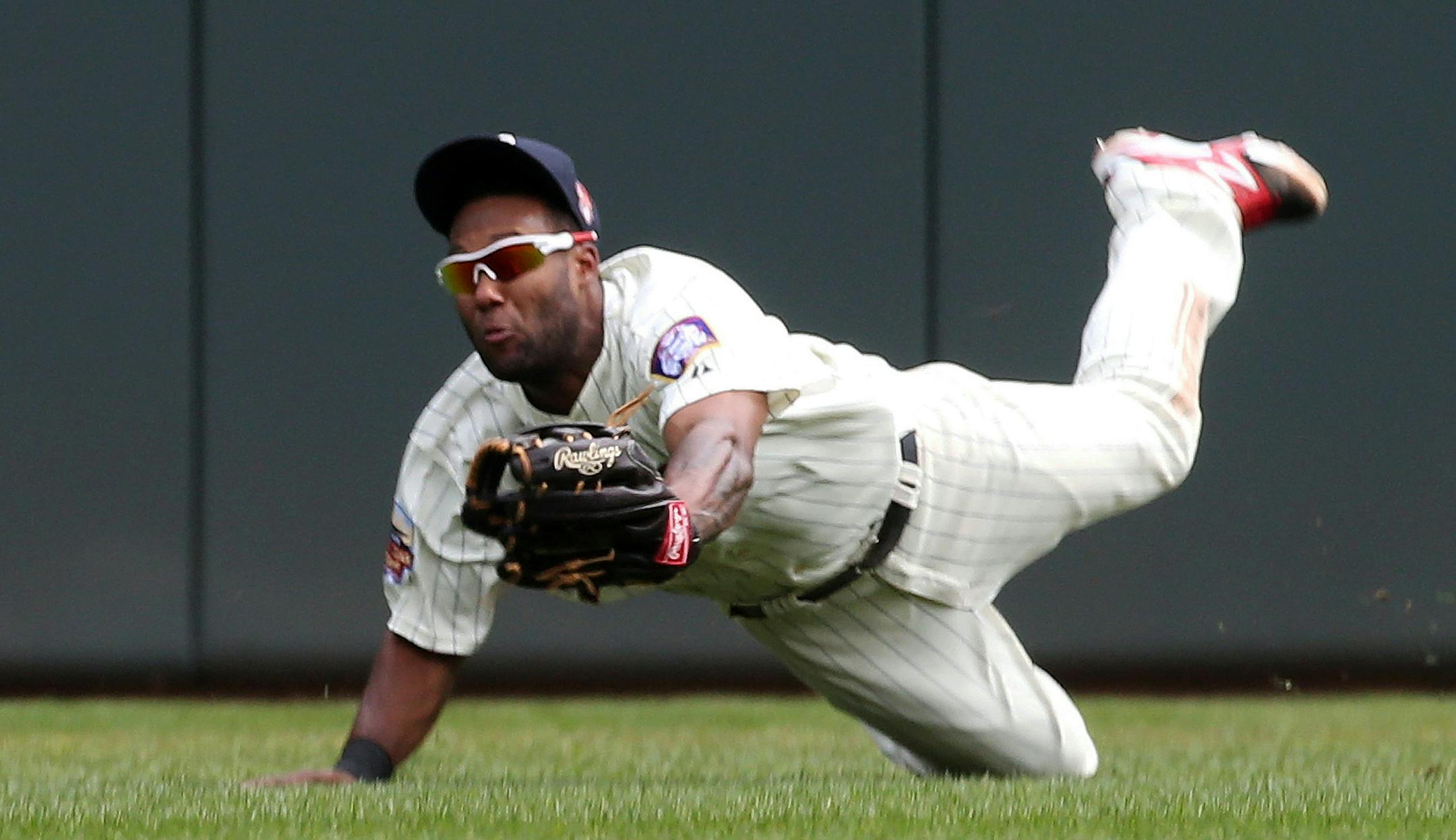 Minnesota Twins center fielder Danny Santana dives to make a catch of a shallow fly ball off the bat of San Diego Padres right fielder Jeff Francoeur in the fifth inning of a baseball game, Wednesday, Aug. 6, 2014, in Minneapolis. (AP Photo/Jim Mone)