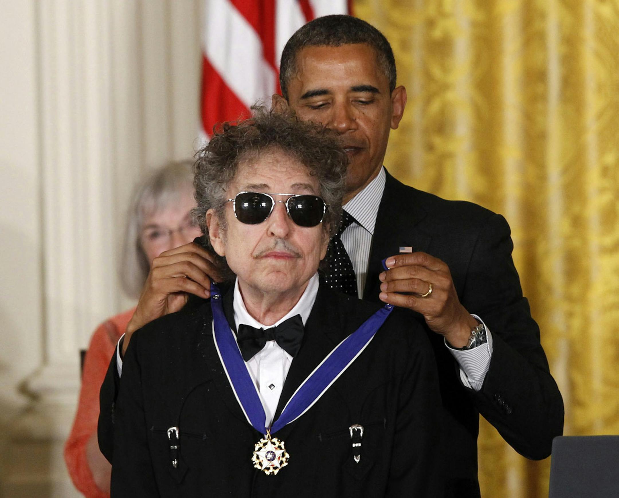 President Barack Obama presents rock legend Bob Dylan with a Medal of Freedom, Tuesday, May 29, 2012, during a ceremony at the White House in Washington.