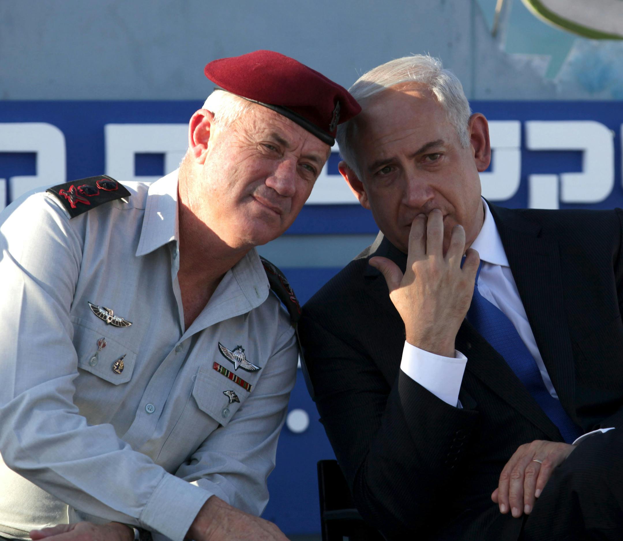 Israeli Prime Minister Benjamin Netanyahu, right, speaks with Israeli Chief of Staff Lt. Gen. Benny Gantz, during a graduation ceremony of navy officers in the northern port city of Haifa, Israel, Wednesday, Sept. 11, 2013. Netanyahu has praised the Russian initiative for Syria to relinquish its chemical weapons but said its backers must verify that Damascus actually follows through and disarms itself of all chemical weapons.(AP Photo/Dan Balilty)