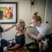 The morning of the Mr. & Ms. National Minnesota Pro North American competition Joanna Pluszcz sat to be groomed with makeup and hair in a hotel room t
