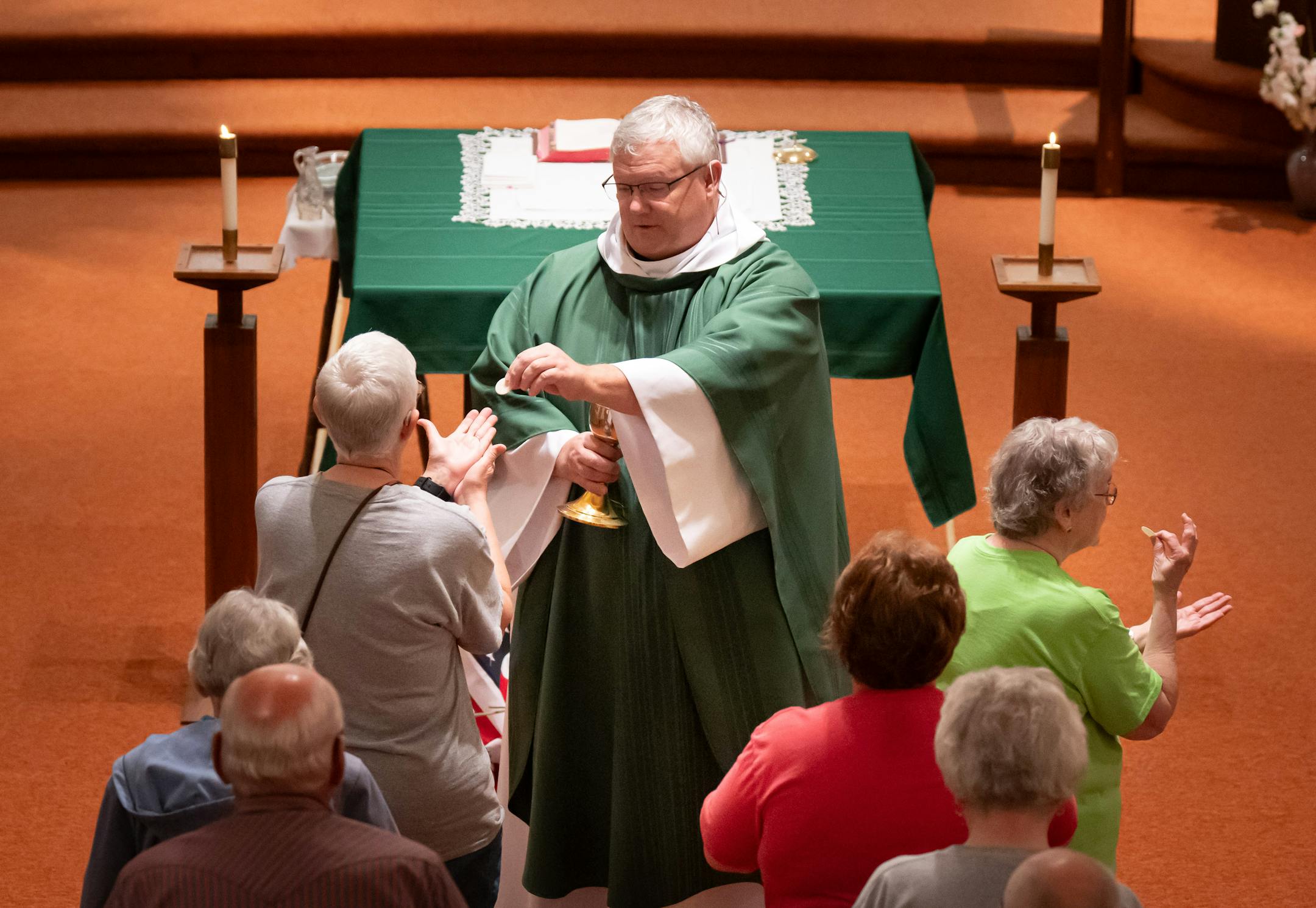 Parishoners stood in line to receive communion during Friday Mass.