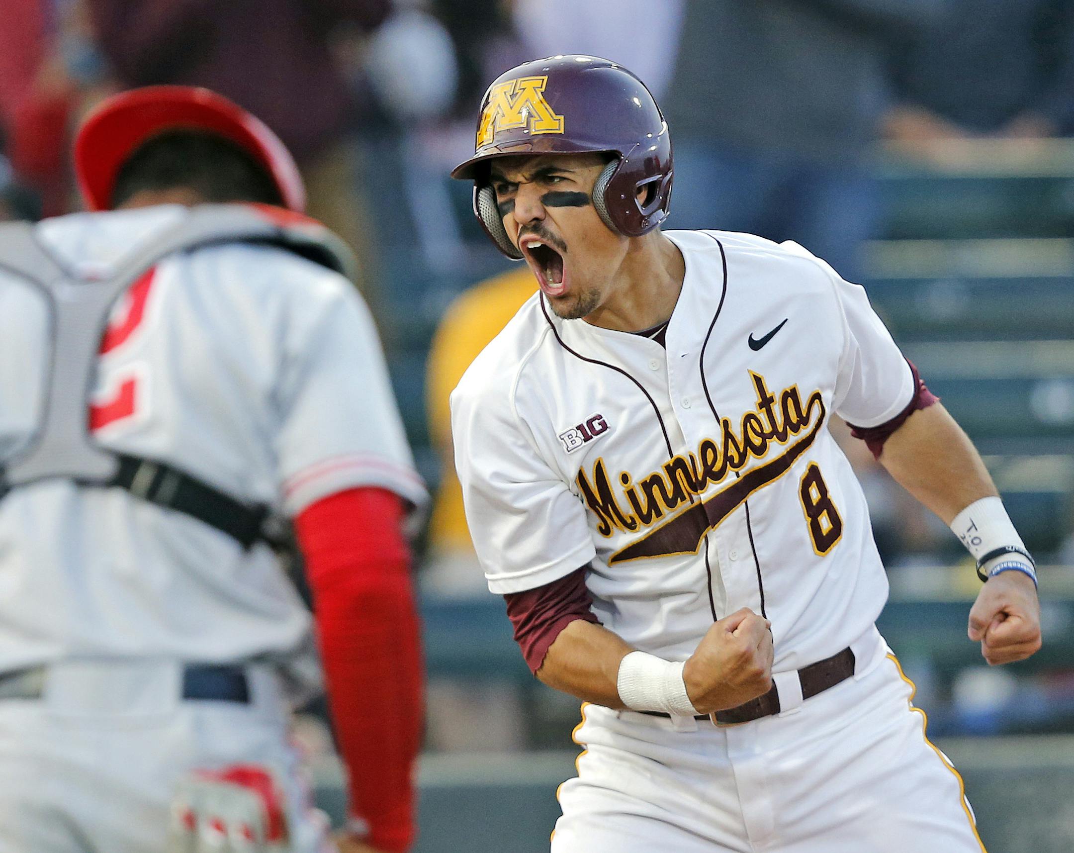 Minnesota's Micah Coffey (8) celebrates the go-ahead and eventual game-winning run on a past ball during the sixth inning against Ohio State at Siebert Field, May 20, 2016. Minnesota clinched the Big Ten regular season championship. Photo/Eric Miller/University of Minnesota