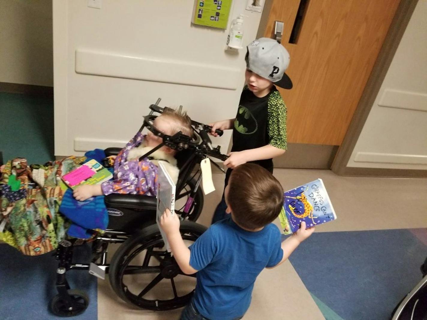 Photo provided by the Peltier family. Kyle Jr. and Konnor try to cheer up Kayden with a ride through the hospital hallway.