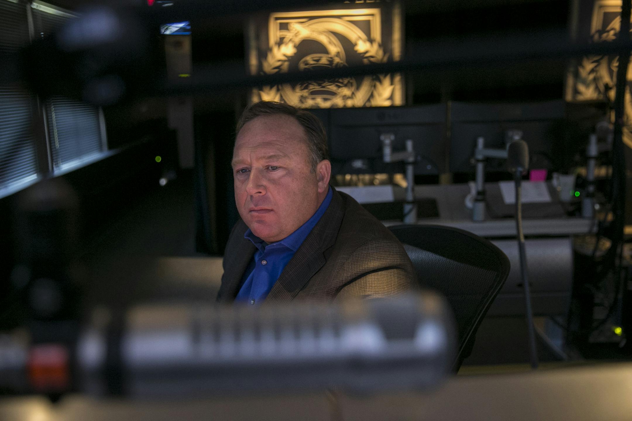 Alex Jones, the conspiracy theorist host of Infowars.com, is pictured in his Austin, Texas, control room, Feb. 17, 2017. Families of some of the 26 people who were killed in the 2012 Sandy Hook Elementary School massacre have criticized an upcoming Megyn Kelly interview with Alex Jones, who has said the shooting was a hoax perpetrated by forces hostile to the Second Amendment.