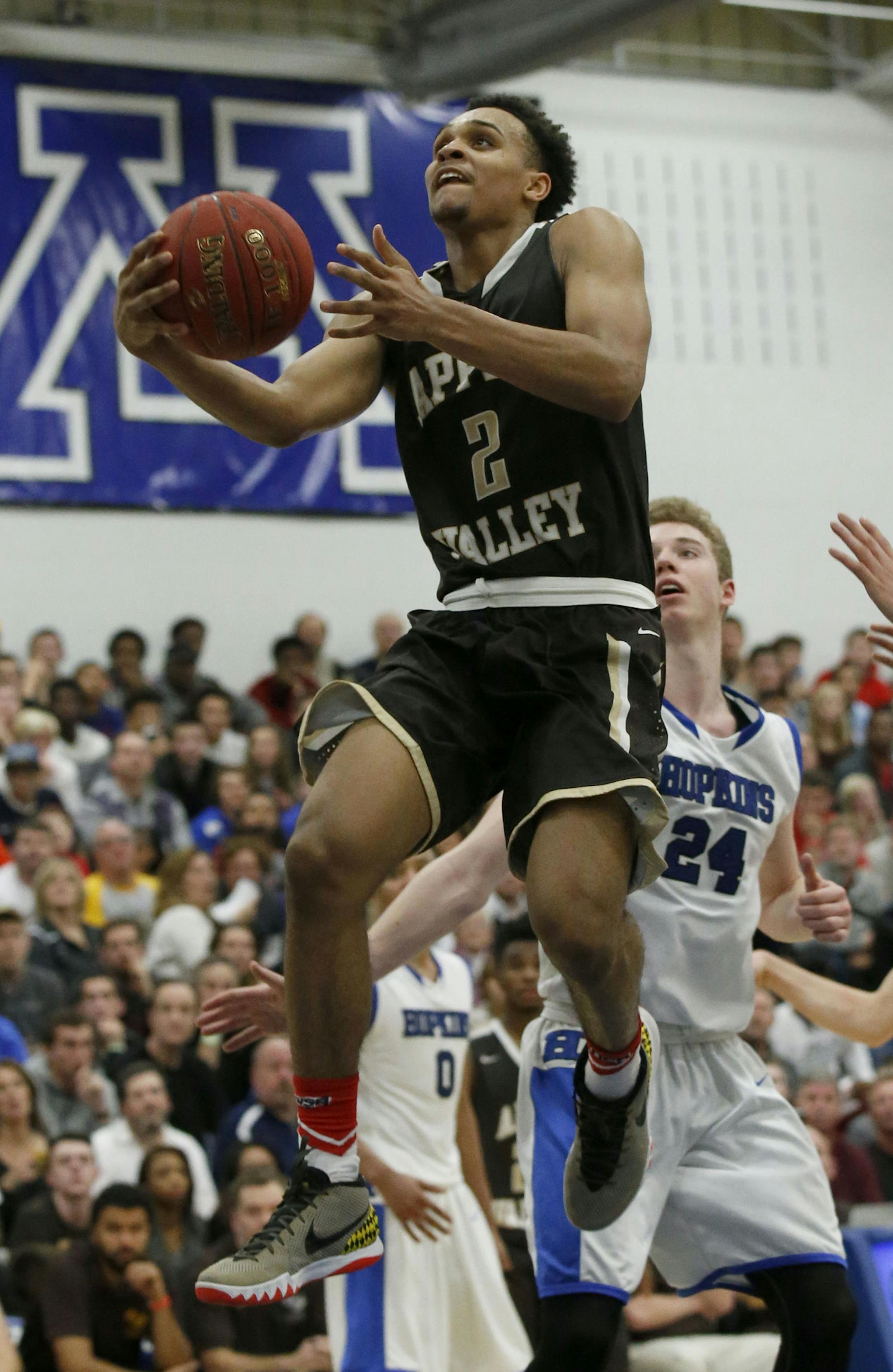 Apple Valley guard Gary Trent Jr. (2) drives to the basket past Hopkins guard Amir Coffey, right, and Hopkins center Eric Davis (24) during the second half in Minnetonka, Saturday, Dec. 12, 2015. Hopkins defeated Apple Valley 89-81. ( Photo/Ann Heisenfelt) ORG XMIT: 596959 prep121315 13