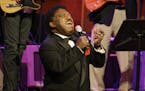 FILE - In this Oct. 28, 2008 file photo, Percy Sledge kneels as he performs "When a Man Loves a Woman" along with the Muscle Shoals Rhythm Section at 