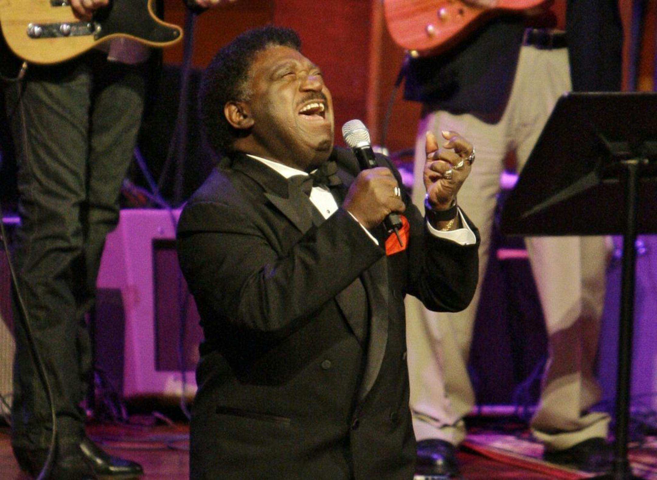 FILE - In this Oct. 28, 2008 file photo, Percy Sledge kneels as he performs "When a Man Loves a Woman" along with the Muscle Shoals Rhythm Section at the Musicians Hall of Fame awards show in Nashville, Tenn. Sledge, who recorded the classic 1966 soul ballad "When a Man Loves a Woman," died, Tuesday April 14, 2015. He was 74.
