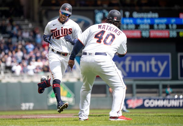 Minnesota Twins center fielder Byron Buxton (25) celebrates his second home run of the game with Minnesota Twins third base coach Tommy Watkins (40) i