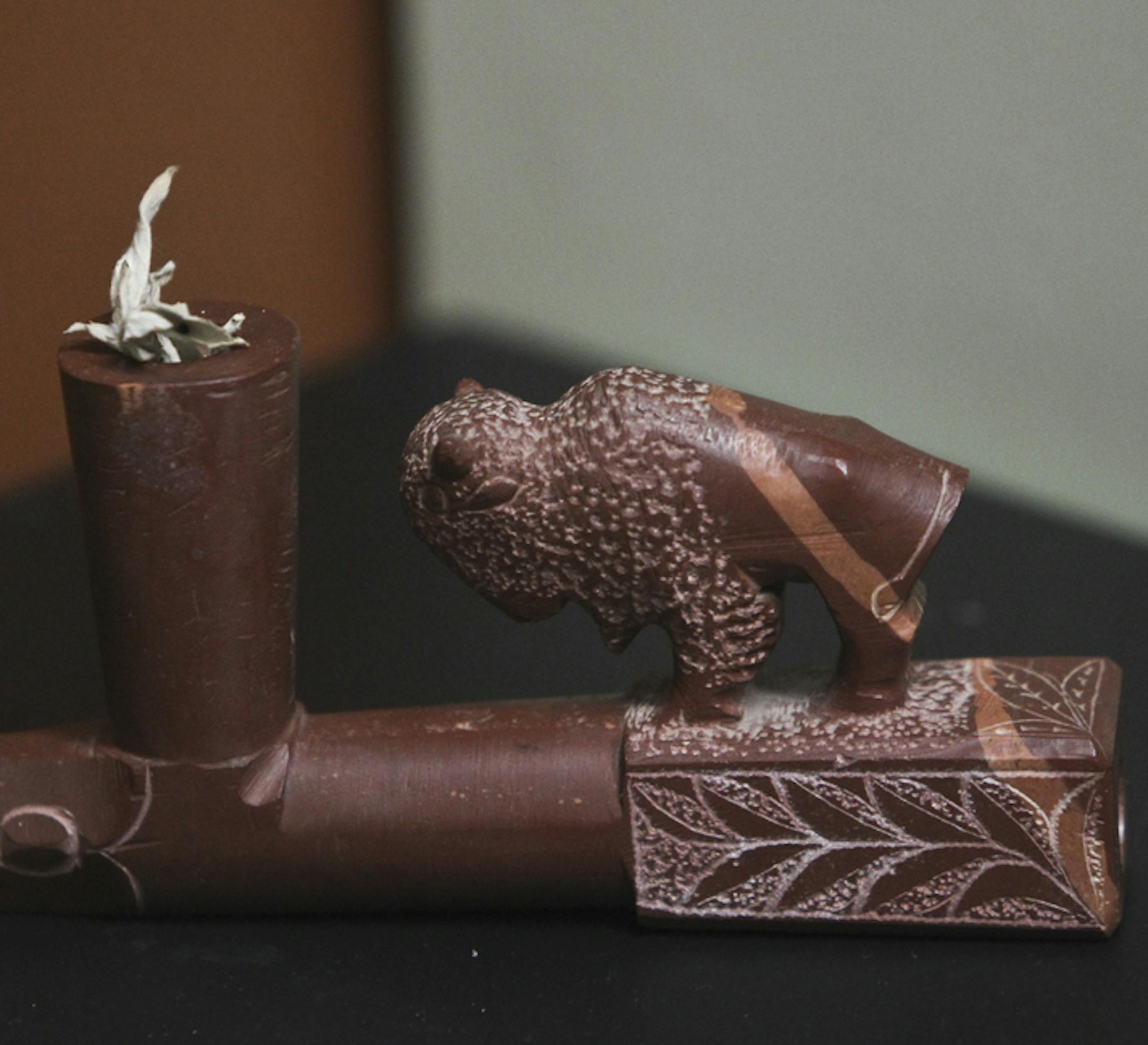 Detail of a Pipestone pipe made by a traditional carver and on display at Pipestone National Monument Thursday, August 16, 2012, in Pipestone, MN.] (DAVID JOLES/STARTRIBUNE) Billy Bryan, who turns 70 next month, is one of the last traditional carvers of Native American pipestone. He has spent his entire life amid the sacred quarries in the southwest corner of the state near Pipestone, where the national monument is celebrating its 75th anniversary. Bryan was photographed near where he quarries a