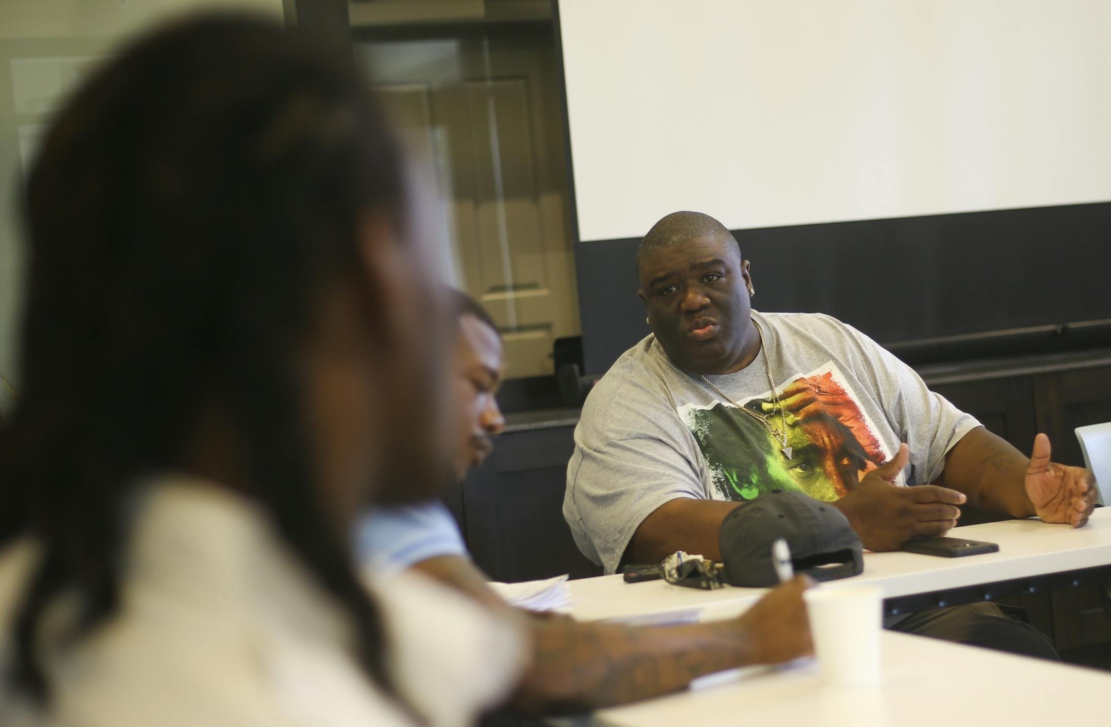 Ferome Brown explains some of the details of the New Day mentorship program and the expectations of the program to his mentors-in-training at EMERGE Community Development on June 27, 2016.