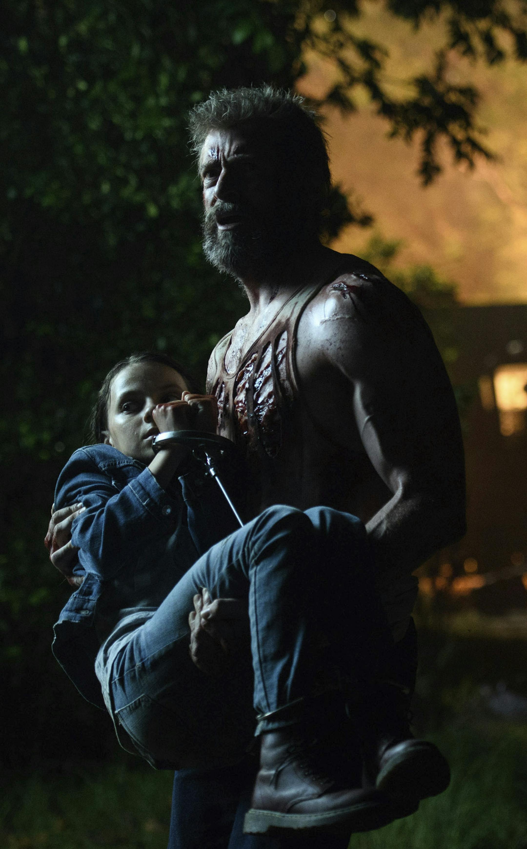 This image released by Twentieth Century Fox shows Dafne Keen, left, and Hugh Jackman in a scene from "Logan." (Ben Rothstein/Twentieth Century Fox via AP)