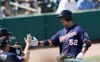 Minnesota Twins' Byung Ho Park (52) is greeted at the dugout after hitting a home run in the third inning of a spring training baseball game against t