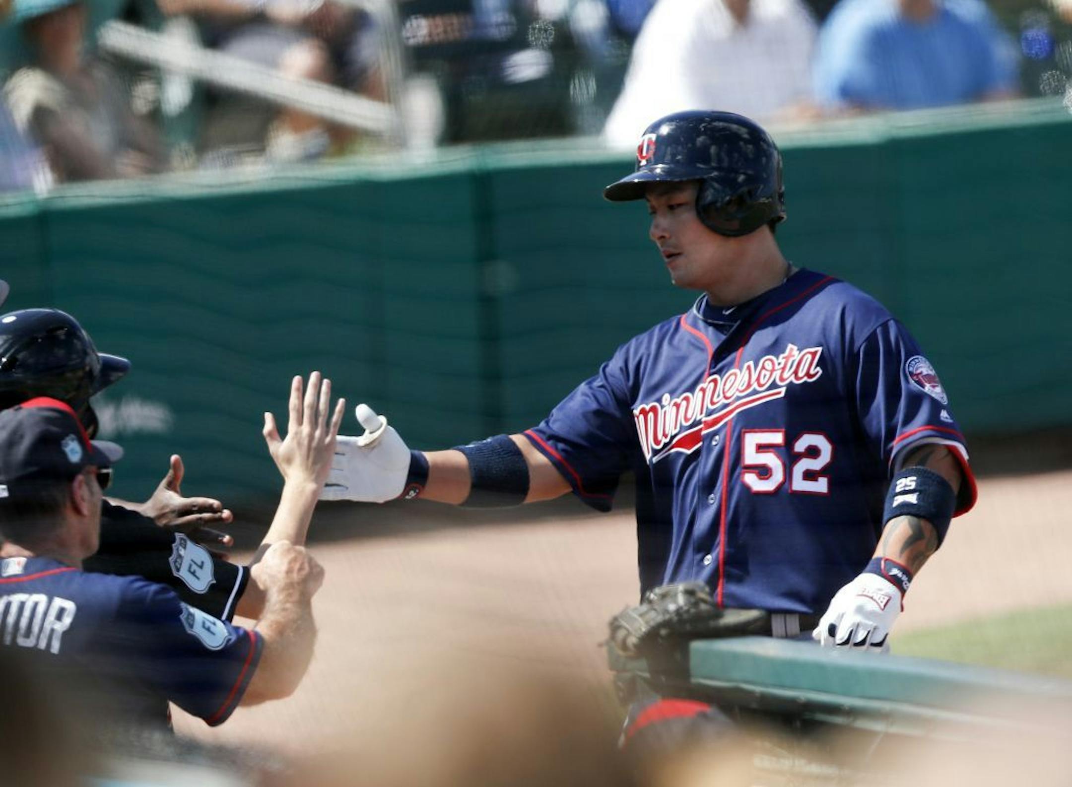 Minnesota Twins' Byung Ho Park (52) is greeted at the dugout after hitting a home run in the third inning of a spring training baseball game against the Miami Marlins Friday, March 10, 2017, in Jupiter, Fla.