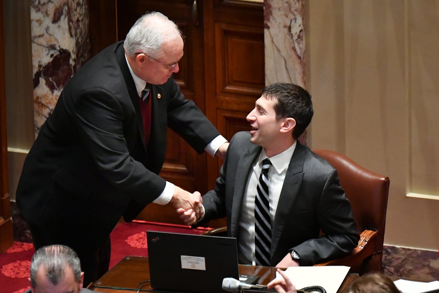 Sen. Jeremy Miller, R-Winona, chief author of the Sunday liquor bill, is congratulated by Sen. Dan Hall, R-Burnsville.