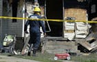 Erie Bureau of Fire Inspector Mark Polanski helps investigate a fatal fire at 1248 West 11th St. in Erie, Pa, on Sunday, Aug. 11, 2019. Authorities sa