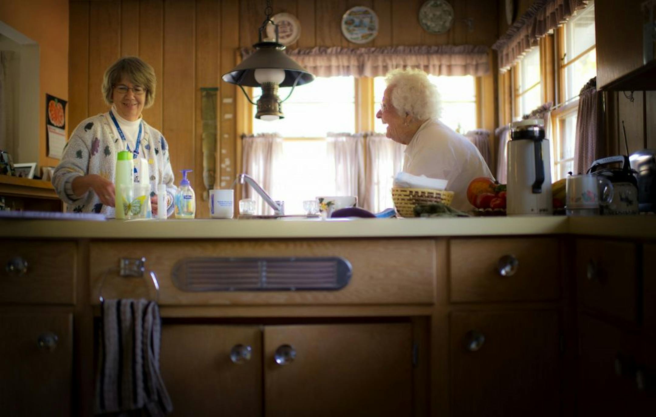 Transition coach Ruth Ratajczak, left, visited with recent hospital patient Beatrice Kellgren in her White Bear Lake home. Coaches review medications and discharge instructions and make house visits as part of a new effort by hospitals to cut down on costly readmissions.