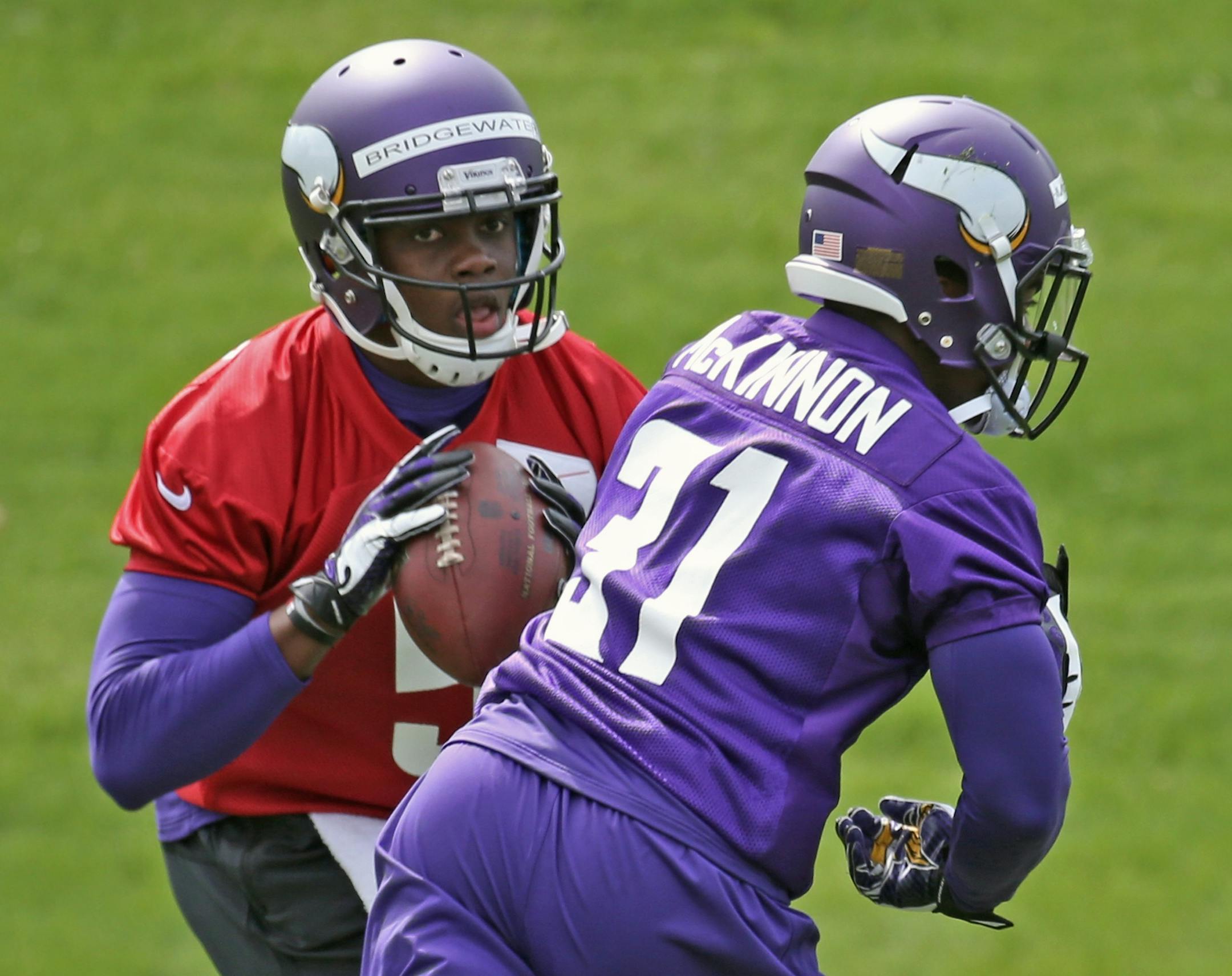 (left to right) Quarterback Teddy Bridgewater faked a hand-off to Jerick McKinnon and dropped back to pass, during the Vikings Rookie Mini Camp at Winter Park on 5/16/14.