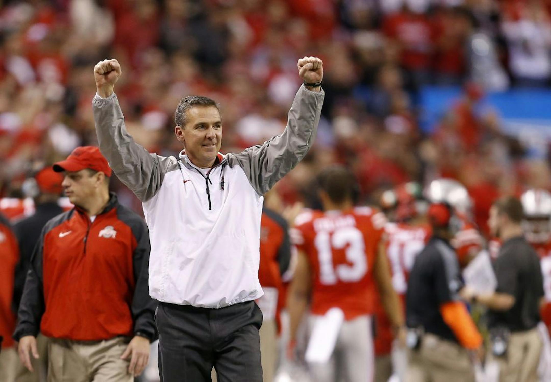 Ohio State head coach Urban Meyer reacts to a late touchdown during a 59-0 win against Wisconsin in the 2014 Big Ten championship game at Lucas Oil Stadium in Indianapolis on Saturday, Dec. 6, 2014.