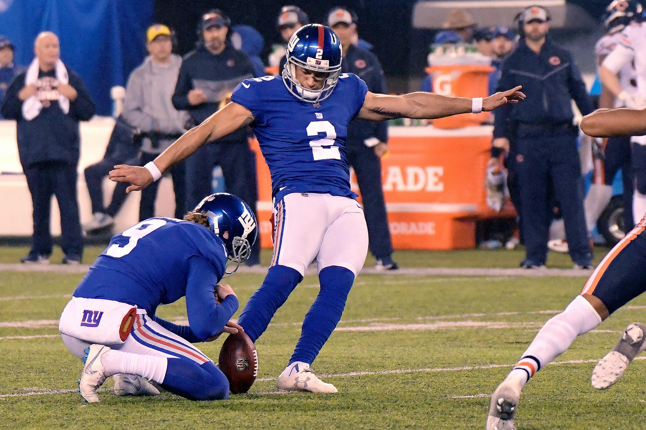 New York Giants kicker Aldrick Rosas (2), with Riley Dixon holding, kicks a field goal during overtime of an NFL football game against the Chicago Bears, Sunday, Dec. 2, 2018, in East Rutherford, N.J. The Giants won 30-27 in overtime. (AP Photo/Bill Kostroun)