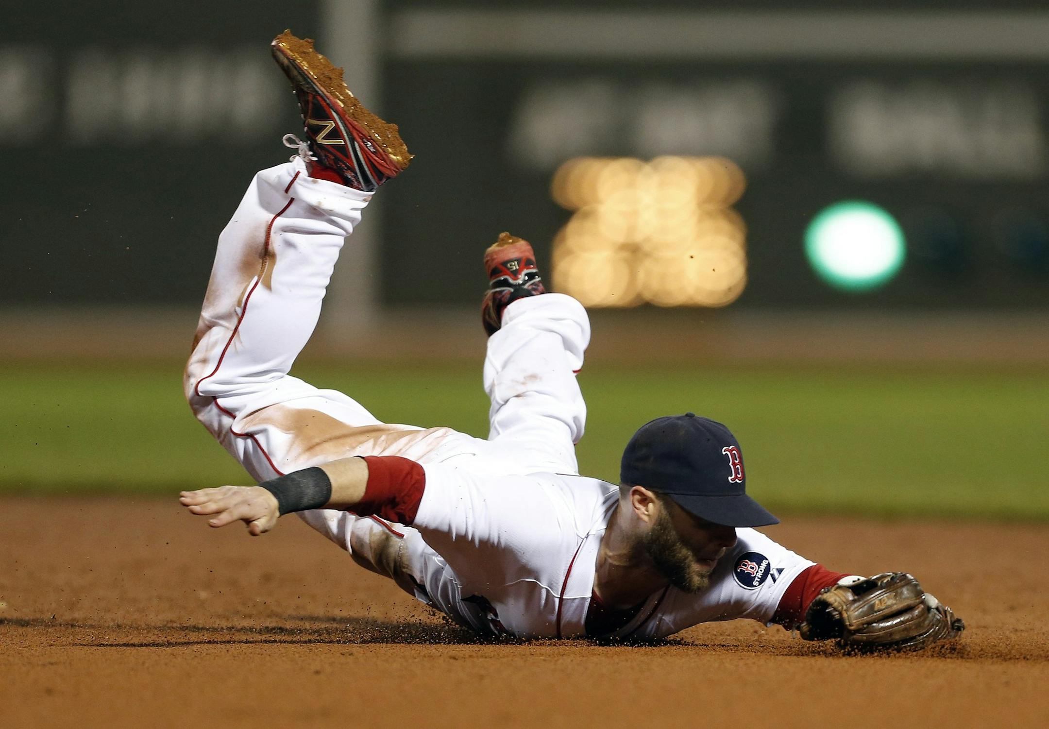 Boston Red Sox's Dustin Pedroia dives for a line drive in the seventh inning of a baseball game against the New York Yankees in Boston, Sunday, July 21, 2013. (AP Photo/Michael Dwyer)