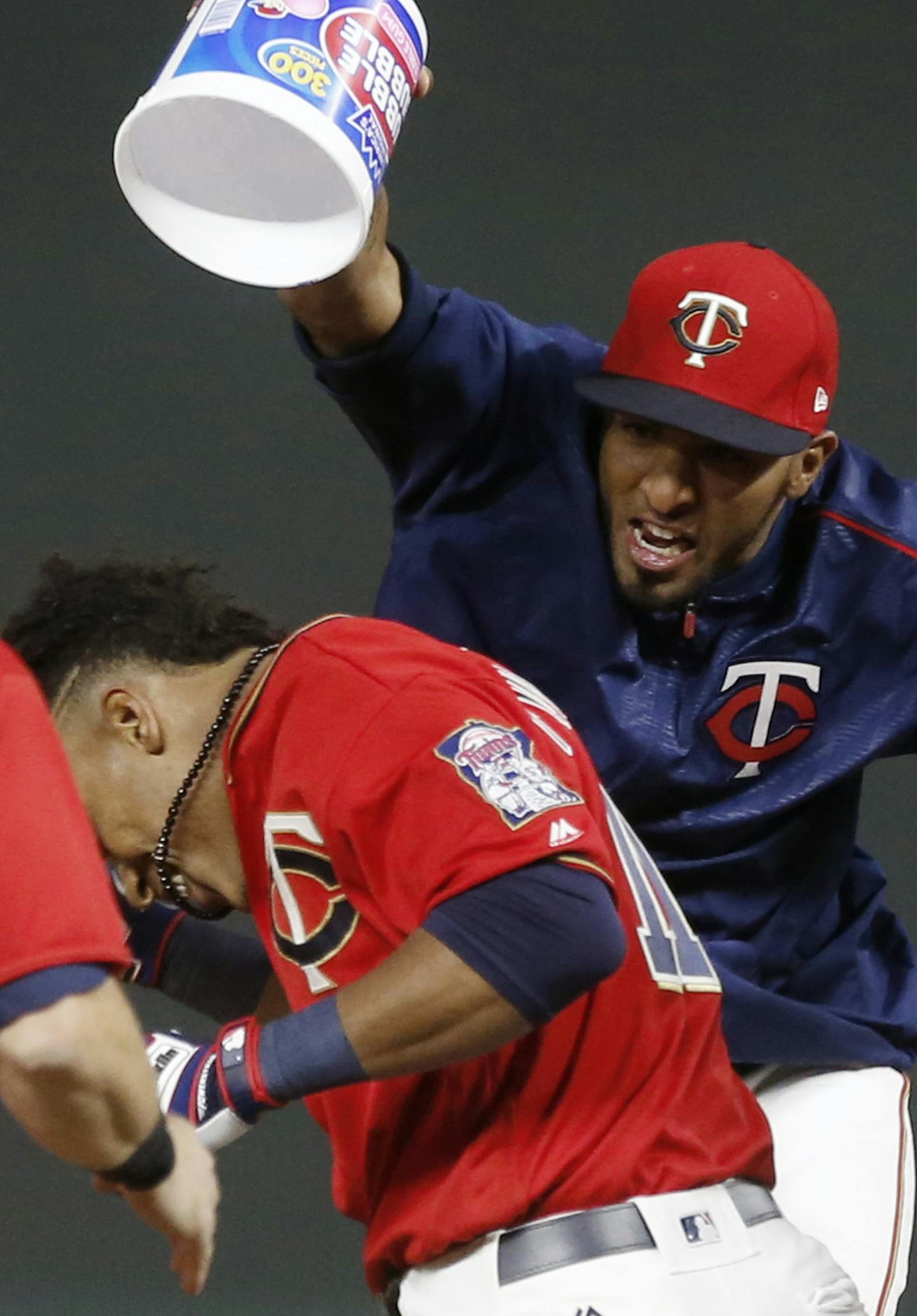 Minnesota Twins' Eddie Rosario, right, looms over Minnesota Twins' Jorge Polanco after dumping bubble gum onto him after his walk-off sacrifice fly in the 10th inning of a baseball game against the Kansas City Royals on Friday, May 19, 2017, in Minneapolis. The Twins won 4-3. (AP Photo/Jim Mone)