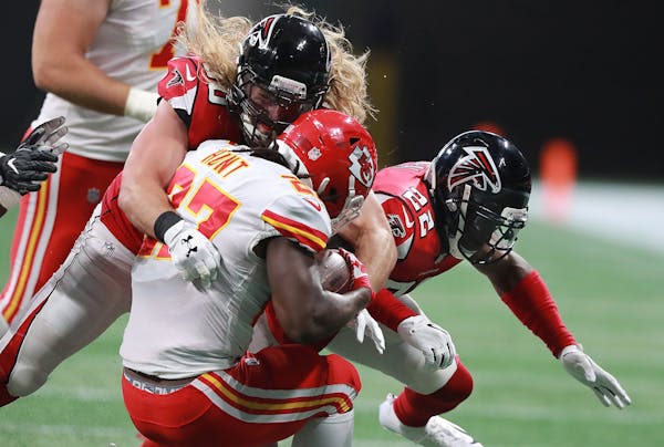 Falcons safety Keanu Neal, right, is called for a helmet penalty for 15 yards hitting Chiefs running back Kareem Hunt with defensive end Brooks Reed d