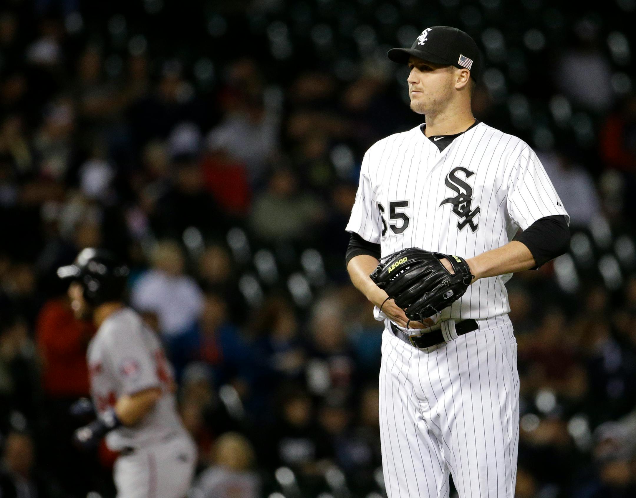 Chicago White Sox relief pitcher Nate Jones looks to home plate after Minnesota Twins' Trevor Plouffe hit a solo home run during the eighth inning of a baseball game, Friday, Sept. 11, 2015, in Chicago. The Twins won 6-2. (AP Photo/Nam Y. Huh)