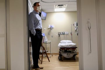 Brent Walters, MD, critical care and emergency medicine physician, in a patient room during a Park Nicollet Methodist Hospital COVID-19 Emergency Room