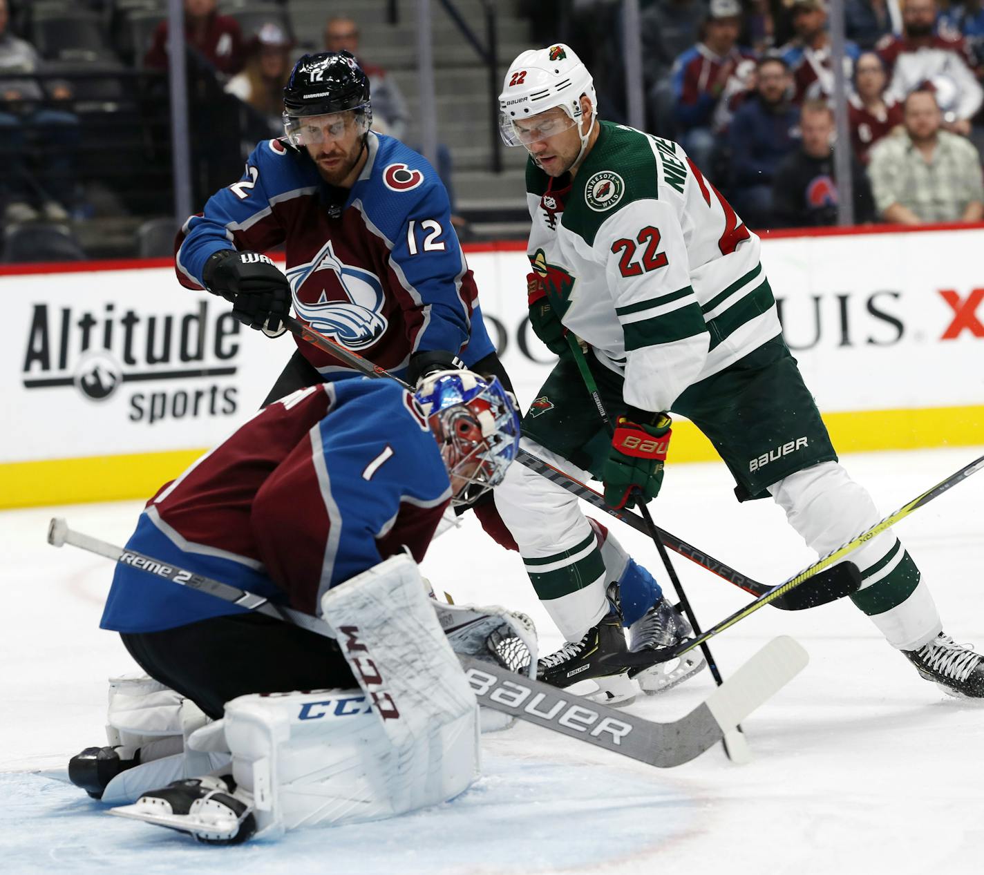 Colorado Avalanche goaltender Semyon Varlamov, front, stops a shot by Minnesota Wild right wing Nino Niederreiter, back right, as Avalanche defenseman Patrik Nemeth watches during the second period of an NHL hockey game Thursday, Oct. 4, 2018, in Denver. (AP Photo/David Zalubowski)