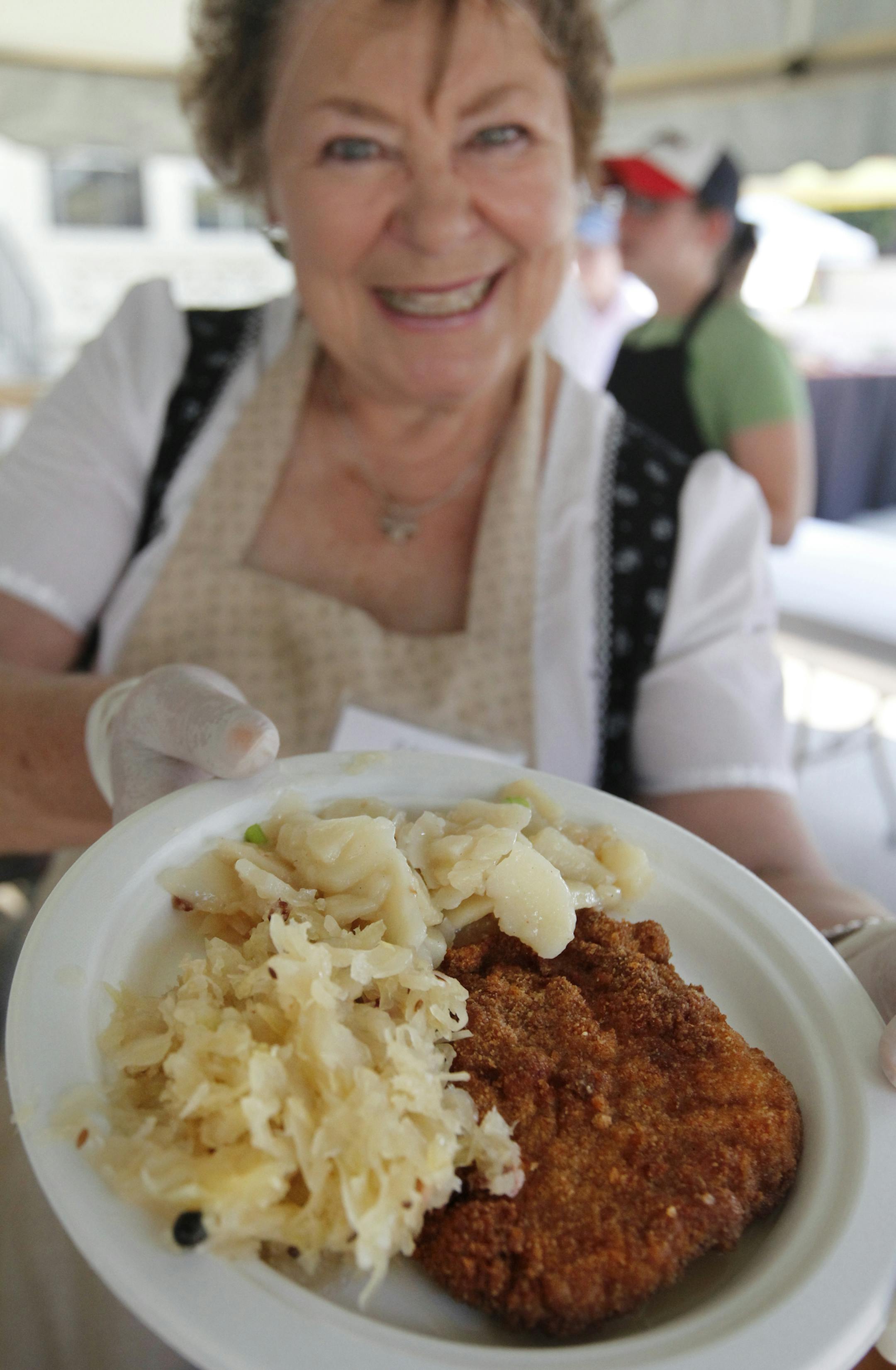 At the festival at the Germanic-American Institute in St. Paul, schnitzel, potato salad, and sauerkraut is a favorite served by volunteer Margarete Lucht.] rtsong-taatarii@startribune.com ORG XMIT: MIN2013052815160529