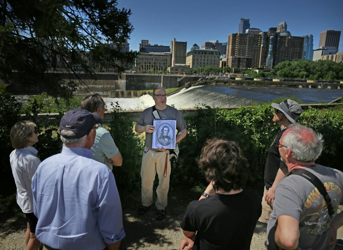 Tour guide Rod Richter, above, told the story of Franklin Steele, the first landowner around the falls who later founded the community of St. Anthony on the river&#x2019;s east bank. Left, Richter explained Father Hennepin&#x2019;s role, and the 1908 Hennepin Island Hydroelectric Plant.