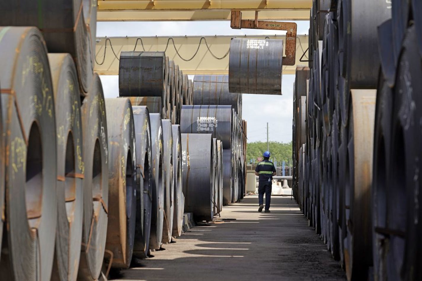 FILE- In this June 5, 2018, file photo, a roll of steel is moved at the Borusan Mannesmann Pipe manufacturing facility in Baytown, Texas. The U.S. has imposed tariffs of up to 25 percent on thousands of goods including raw metals and finished products from China, Mexico, Canada, India and the European nations, and those countries have retaliated with tariffs of their own on U.S. products ranging from agricultural products to boats. The Institute for Supply Management, said some of its members ha