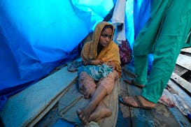 25-year-old Jahanara Khatoon nurses her newborn daughter, born on the boat over the river Brahmaputra, in the northeastern Indian state of Assam, Wedn