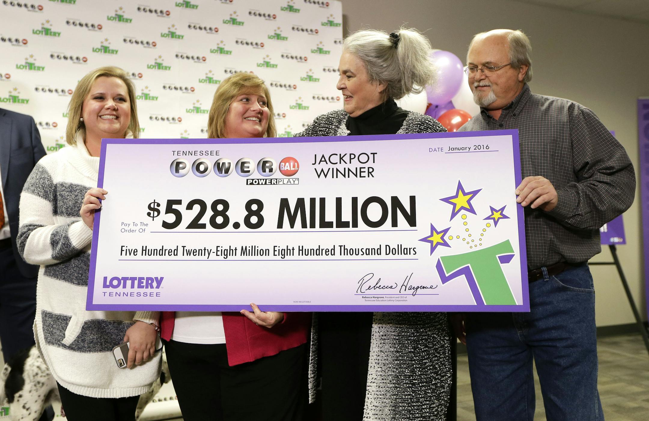 Two days after the drawing, a Tennessee family claimed their share of the record Powerball prize. Rebecca Hargrove, second from right, president and CEO of the Tennessee Lottery, presents a ceremonial check to John Robinson, right; his wife, Lisa, second from left; and their daughter, Tiffany, left; after the Robinson's winning Powerball ticket was authenticated at the Tennessee Lottery headquarters Friday, Jan. 15, 2016, in Nashville.