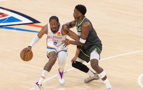 Anthony Edwards (5) of the Timberwolves defends Jalen Williams (8) of the Oklahoma City Thunder in the first quarter.