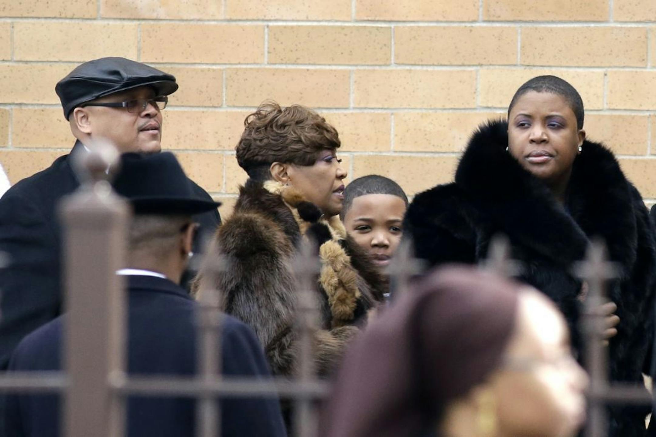 Father Nathaniel Pendleton, left, his son Nathaniel Jr. and mother Cleopatra Pendleton, right, arrive for the funeral of their daughter and sister Hadiya Pendleton at the Greater Harvest Missionary Baptist Church Saturday, Feb. 9, 2013, in Chicago. The shooting death of the 15-year-old honor student has drawn attention to the staggering gun violence in the nation's third-largest city.