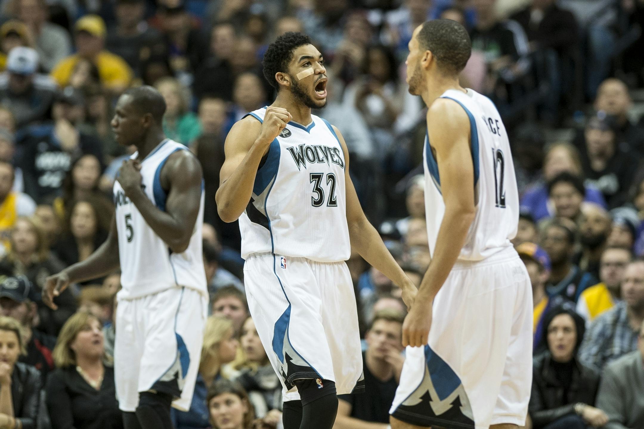 Minnesota Timberwolves center Karl-Anthony Towns (32) celebrated after guard Andrew Wiggins (22) drew a shooting foul in the fourth quarter against the Lakers.