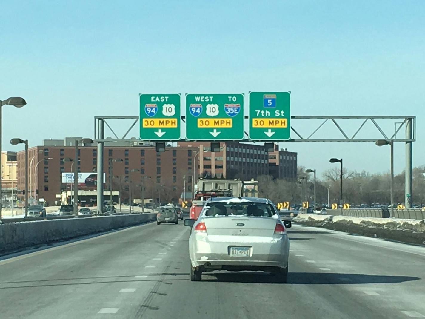 Signs on the Lafayette Bridge direct motorists to the proper lanes, but many don't heed them until the last moment.