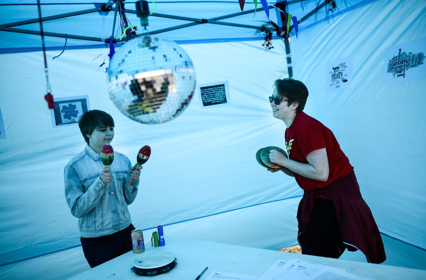 Academy of Whole Learning freshman Erin Smith, 16, left, and sophomore Gray Kruse, 16, used noise makers in a "sensory overload experience" booth for attendees of Tuesday's ribbon cutting ceremony. ] AARON LAVINSKY &#xef; aaron.lavinsky@startribune.com Academy of whole learning, a private school in Minnetonka and one of the only schools to serve autistic children, is inviting people to their new facility. The school is unique in the sense that it is equipped with special facilities, like dim-lig