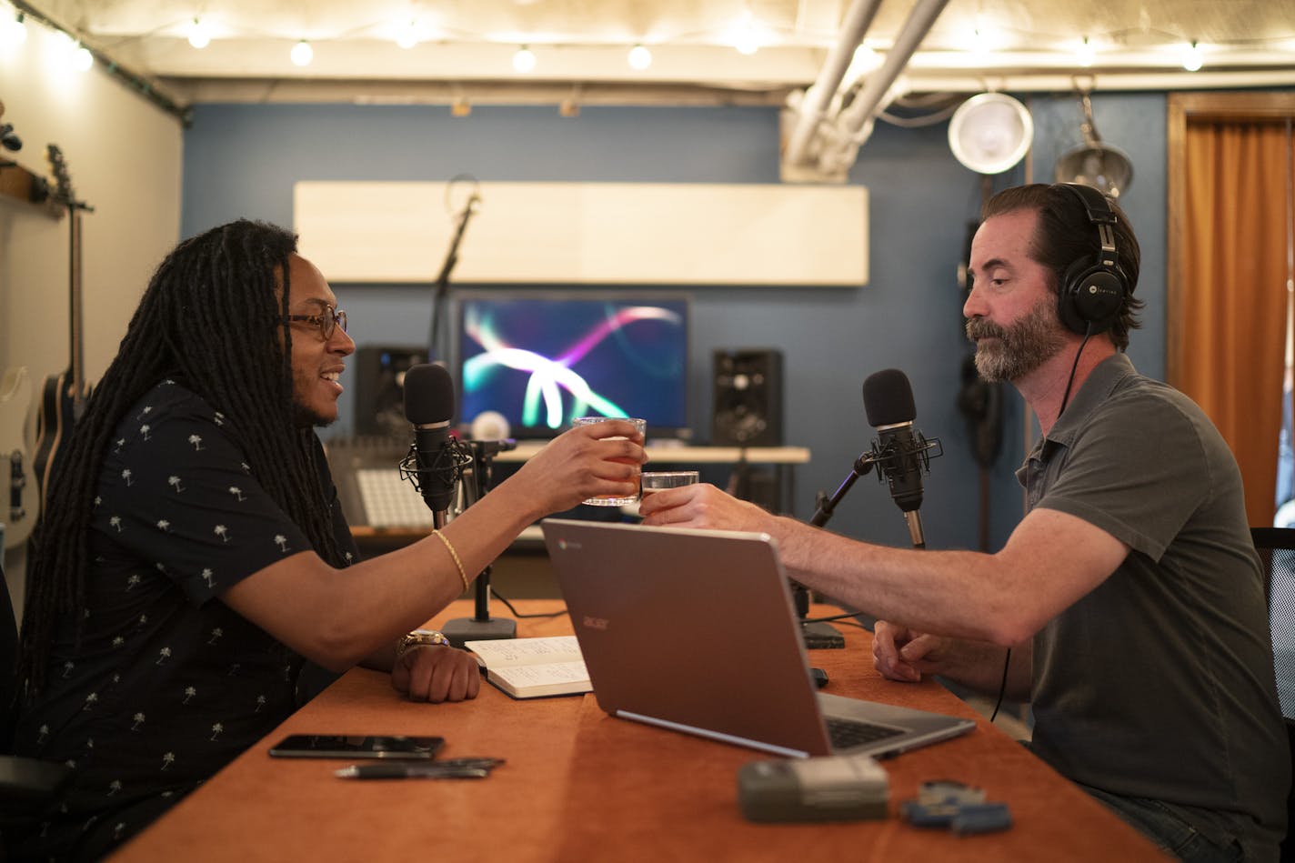 Garrett McQueen, left, and Scott Blankenship toasted each other as they started to record another segment of their podcast, Trilloquy, in Blankenship's basement. Blankenship also brewed the beer in the basement.