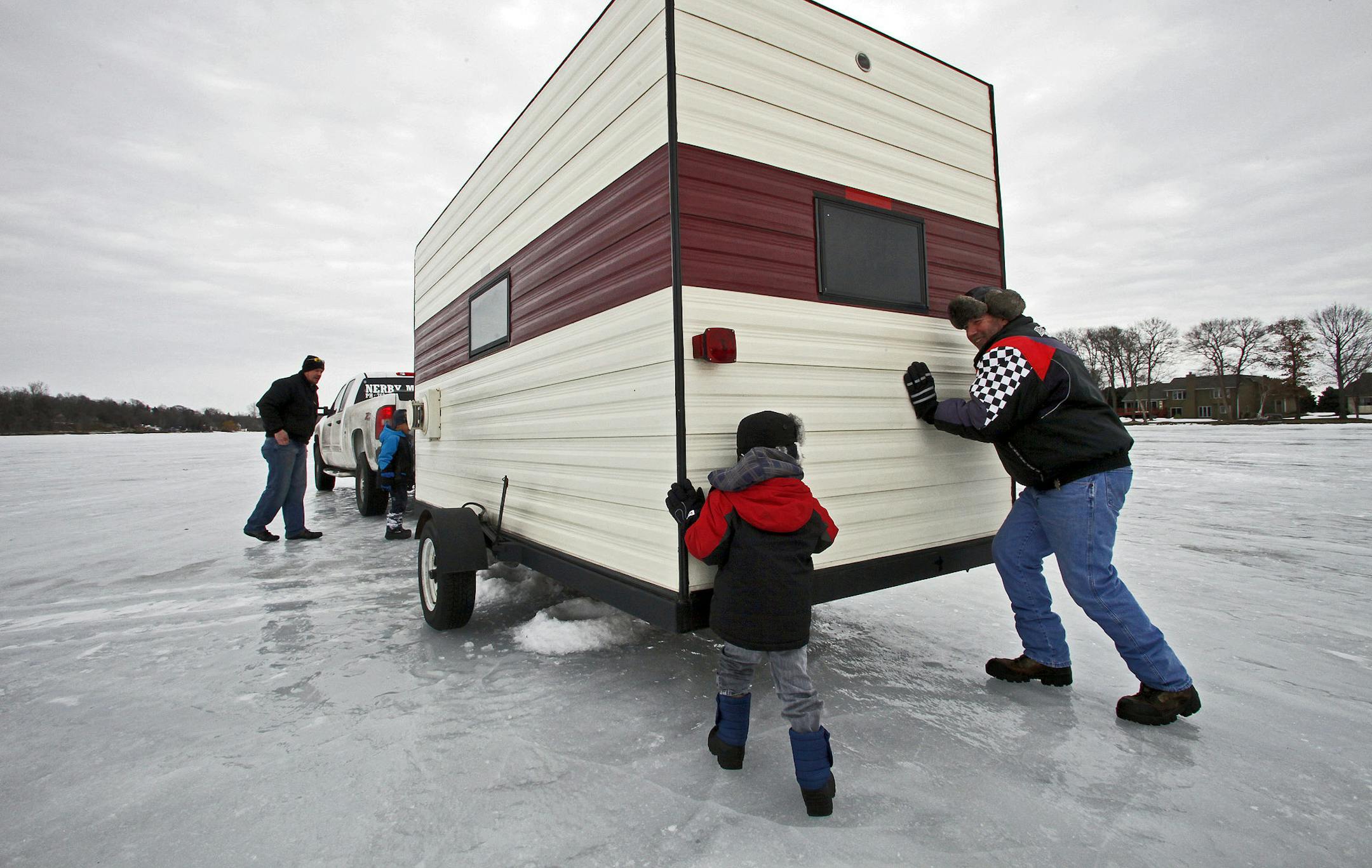 MARLIN LEVISON*mlevison@startribune.com GENERAL INFORMATION Ice fishing houses must be pulled off Washington County area waterways by March 7. The Nerby family of Brooklyn Park took their fish house off Forest Lake this weekend. IN THIS PHOTO: ] Kody Randolph, 6 of Brooklyn Park and Ken Fromn of Forest Lake pushed the ice house towards the trailer hitch on the family truck as Shawn Nerby and son Dominic Nerby, 6 of Brooklyn Park looked on. ORG XMIT: MIN2013022313352911