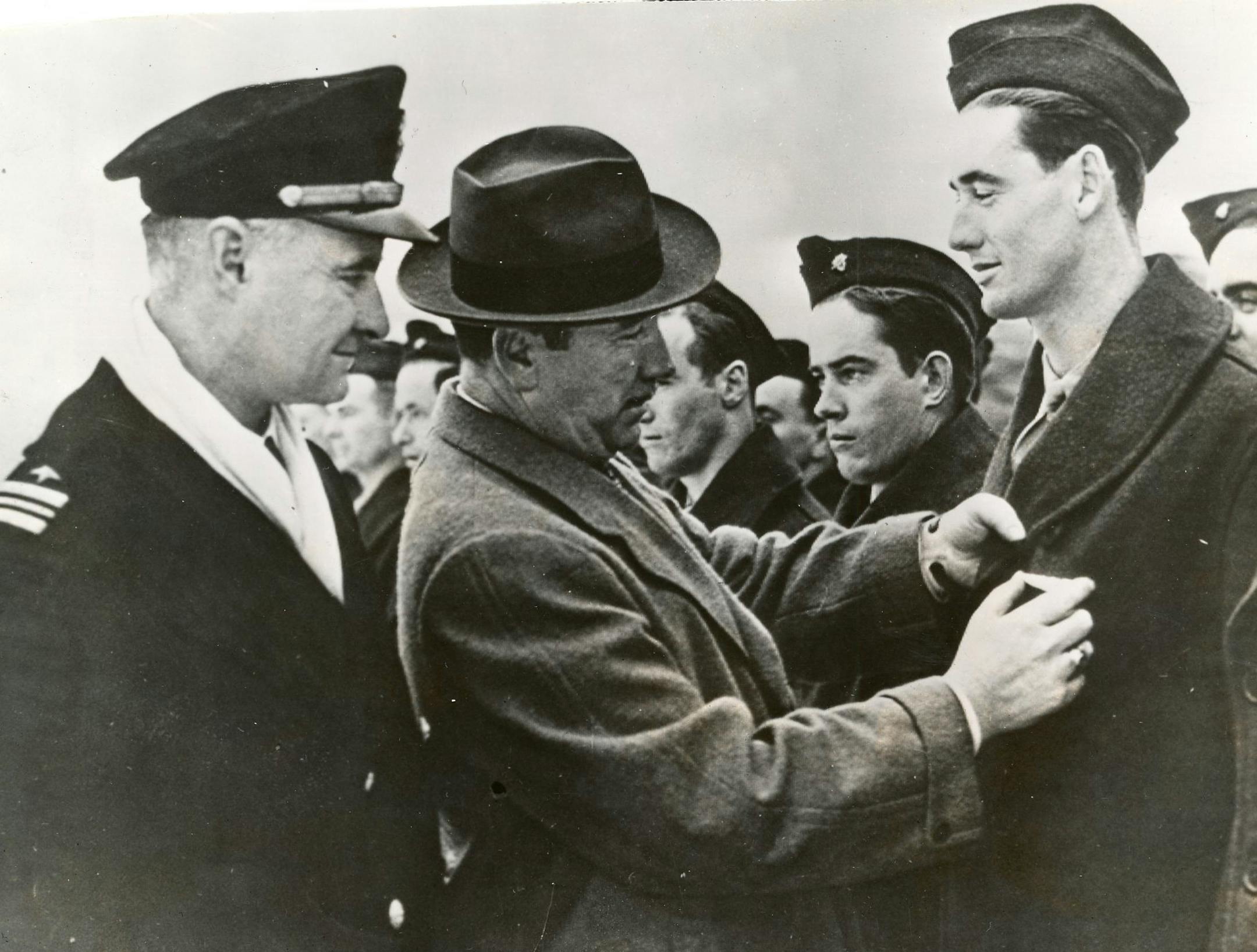 Ted Williams, right, being given a military pin.