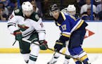Minnesota Wild's Martin Hanzal, of the Czech Republic, and St. Louis Blues' Jaden Schwartz, right, chase the loose puck during the second period in Ga