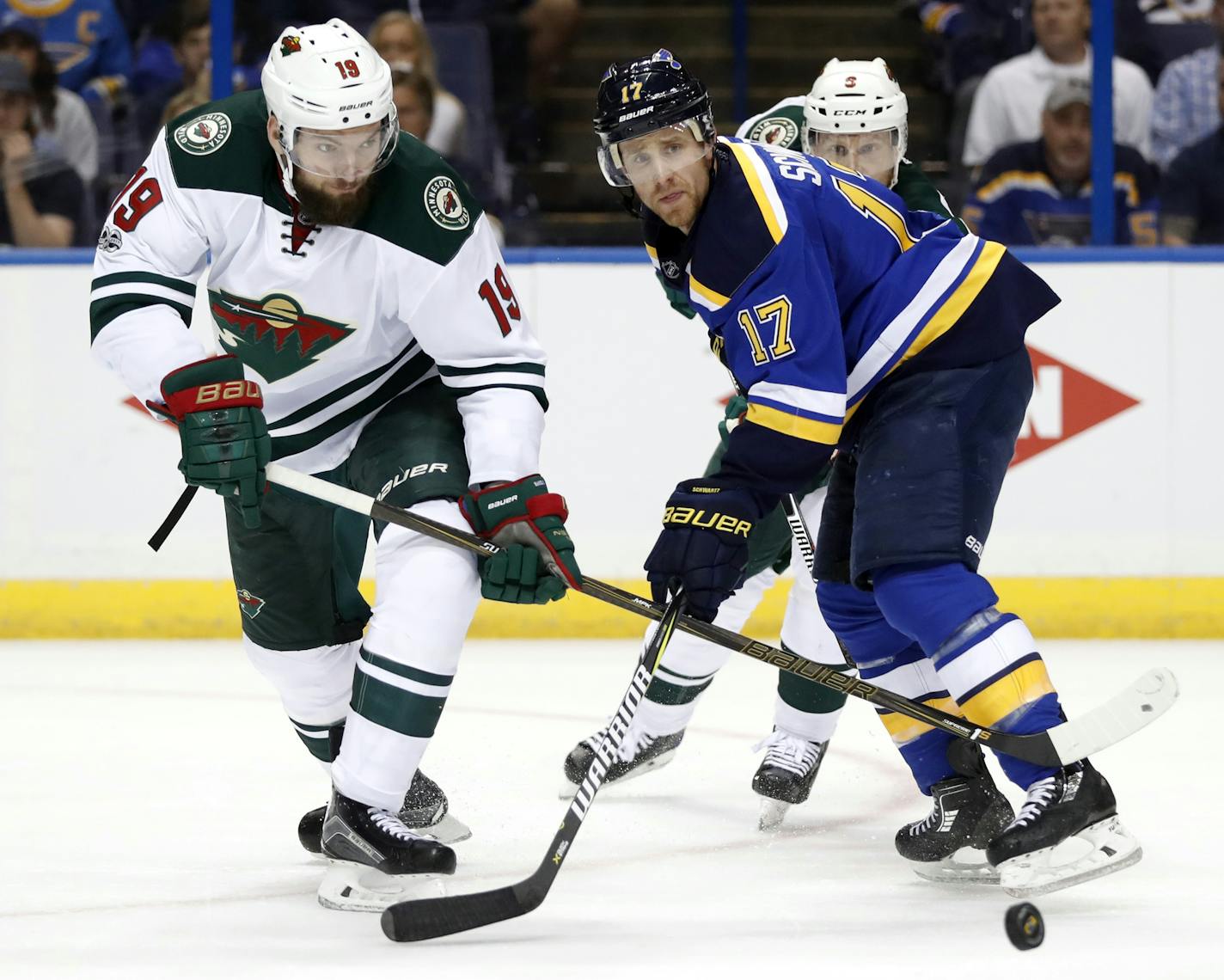 Minnesota Wild's Martin Hanzal, of the Czech Republic, and St. Louis Blues' Jaden Schwartz, right, chase the loose puck during the second period in Game 4 of an NHL hockey first-round playoff series Wednesday, April 19, 2017, in St. Louis. (AP Photo/Jeff Roberson)