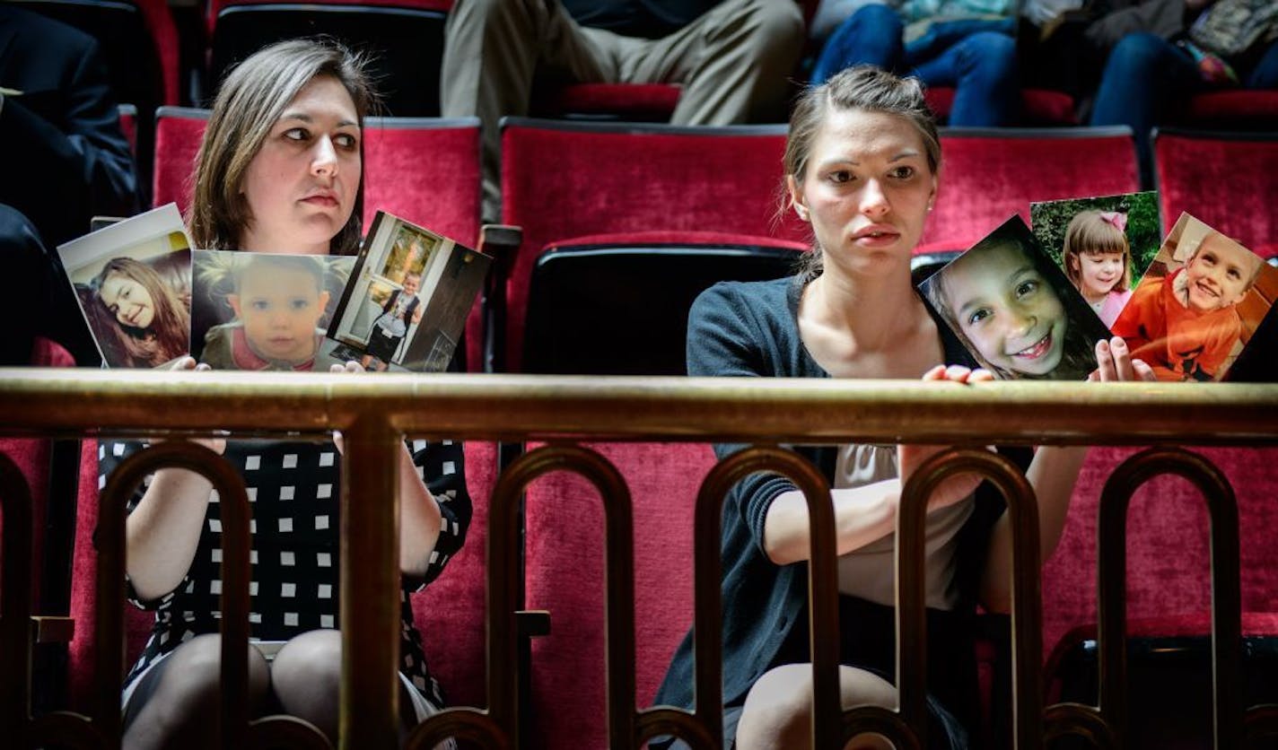 Advocates for Medical marijuana held photos of relatives, loved ones and members of families who couldn't attend the hearing as the bill was debated on the Senate floor. L to R are Kendra Miller and Angela Garin.