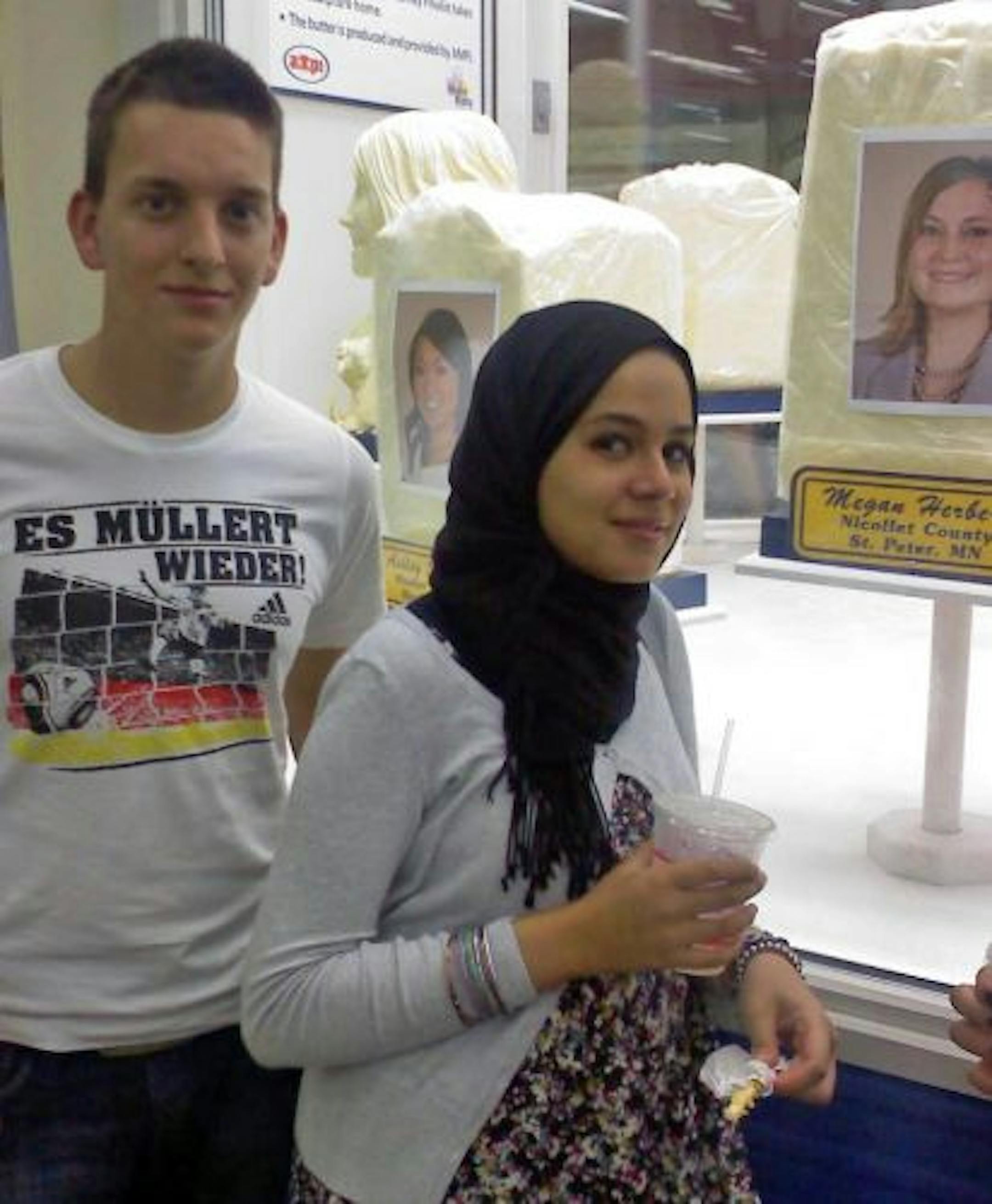 Max Kern, 17, of Germany, and Nada Ali, 15, of Kuwait, get their fill of butter at the State Fair dairy building.