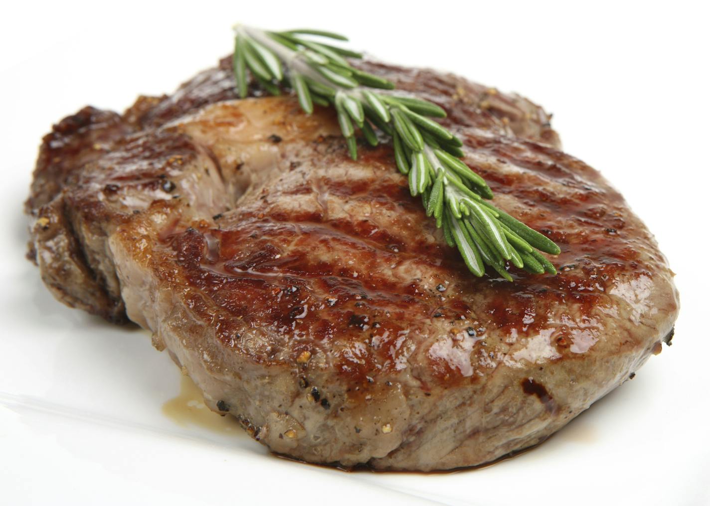 Juicy rib-eye steak resting after being griddled.