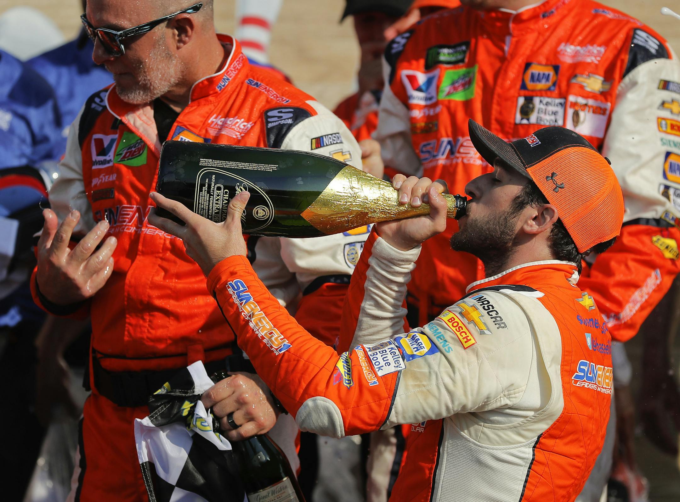 Chase Elliott takes a sip of champagne after winning a NASCAR CupSeries auto race in August.